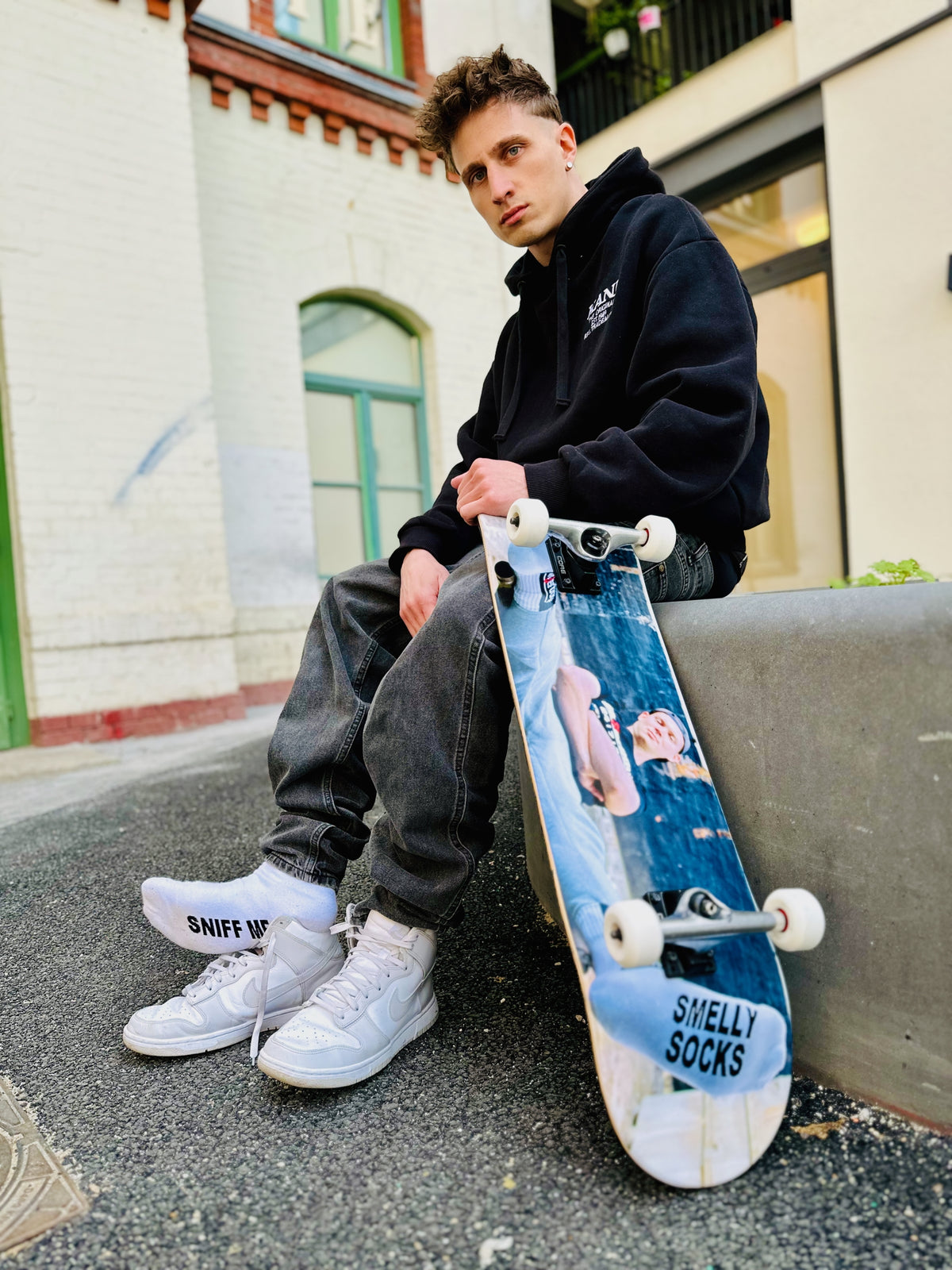 Close-up of white fetish socks with SNFF ME print – Sk8erboy® socks as a provocative fetish statement in an urban skater look.