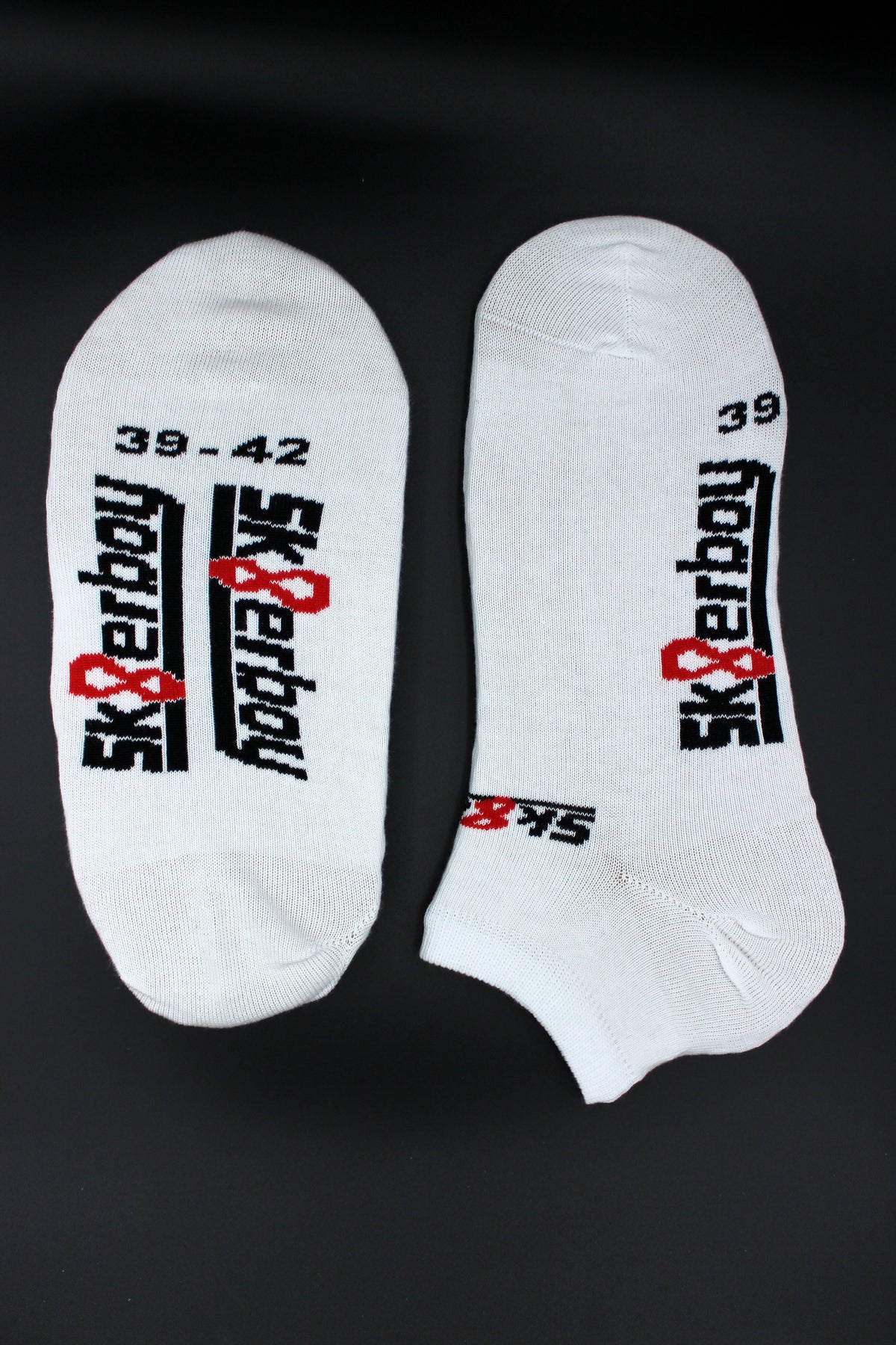 Close-up of sk8erboy sneaker socks for summer in Nike or Adidas trainers, with a large logo on the sole.